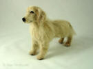 young Golden Retriever handmade of wool, facing left