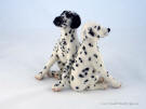 A pair of felted Dalmatians, facing opposite directions