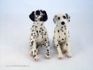 Needle felted Dalmatians, facing front, in sitting position