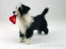 Prince carrying a heart, felted Border Collie statue
