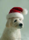 Golden Retriever pup with a Santa hat, felted